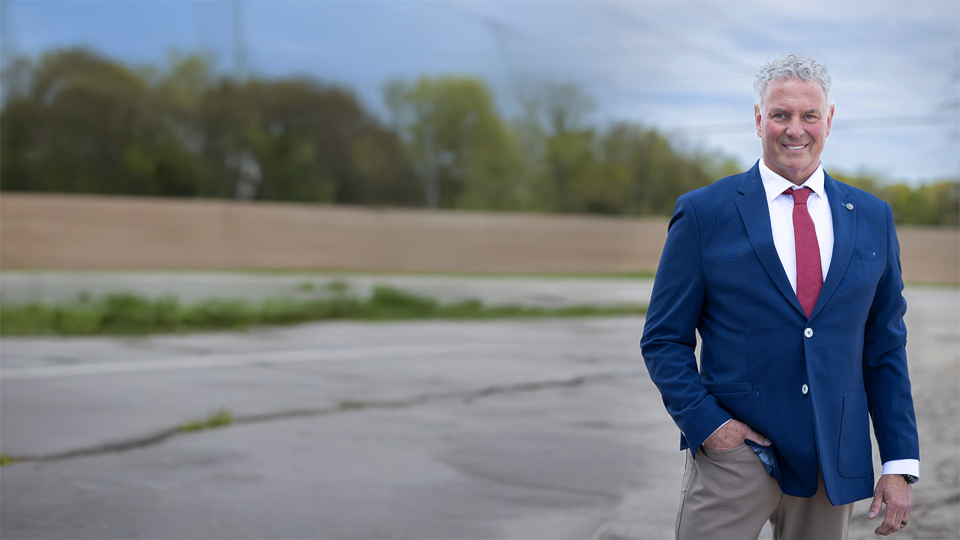 Image of Kevin Coyle in a Suit and Tie posing outside