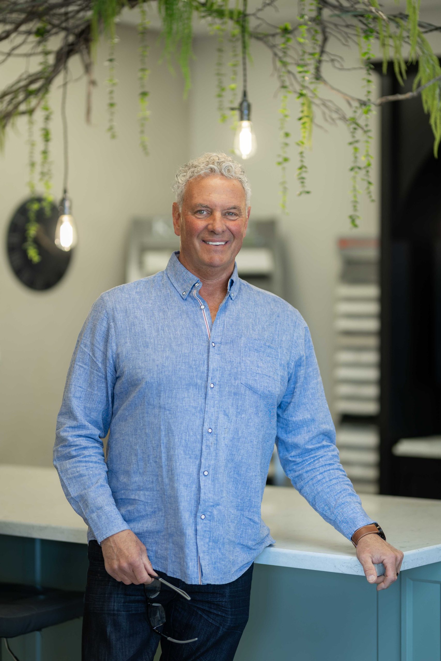 Picture of Kevin Coyle leaning on a an island in his shop